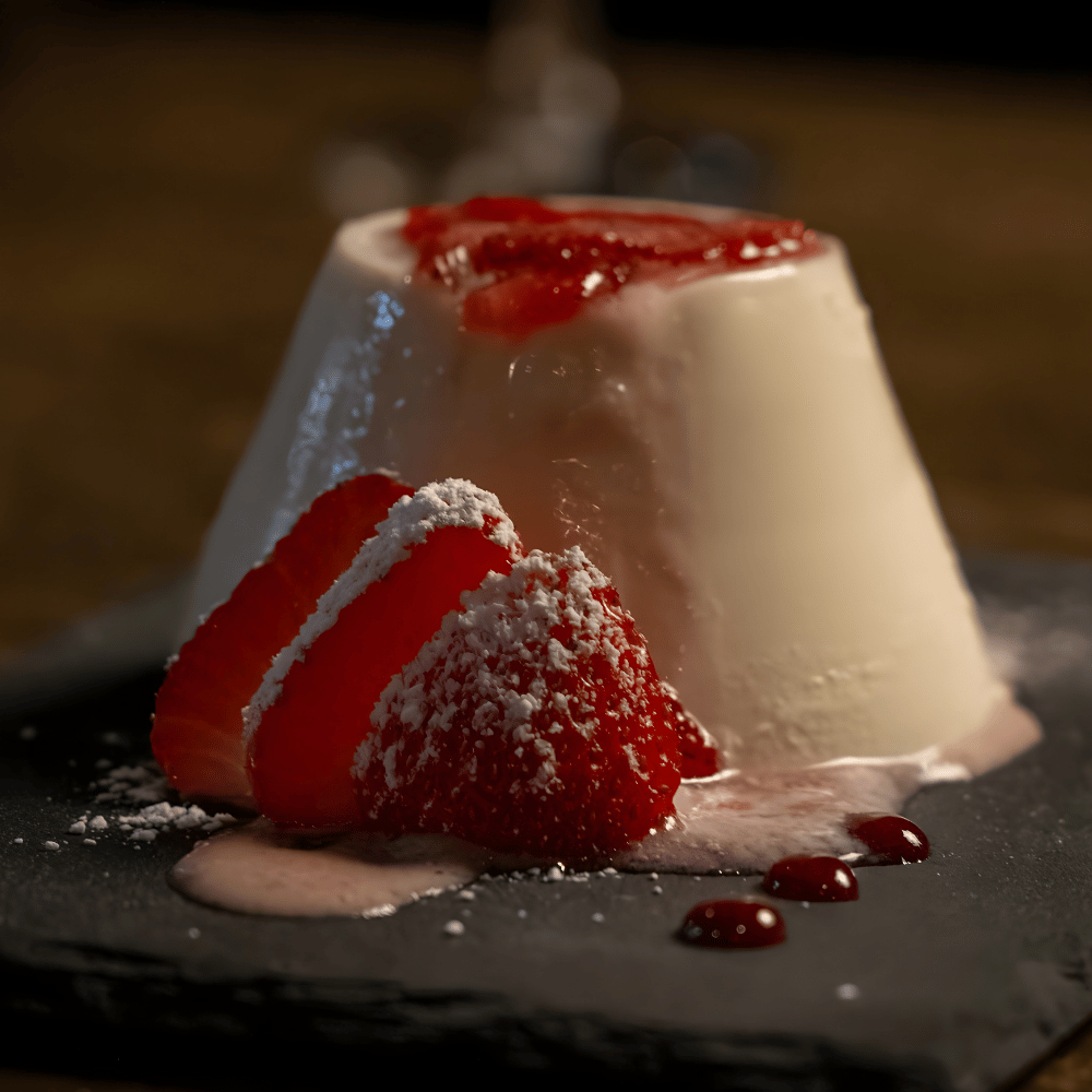 Dessert with white cream, red fruit, and powdered sugar on a dark surface